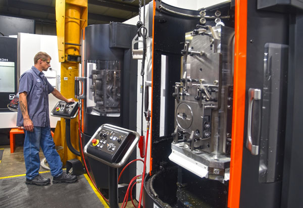 A to Z employee monitoring a CNC machine