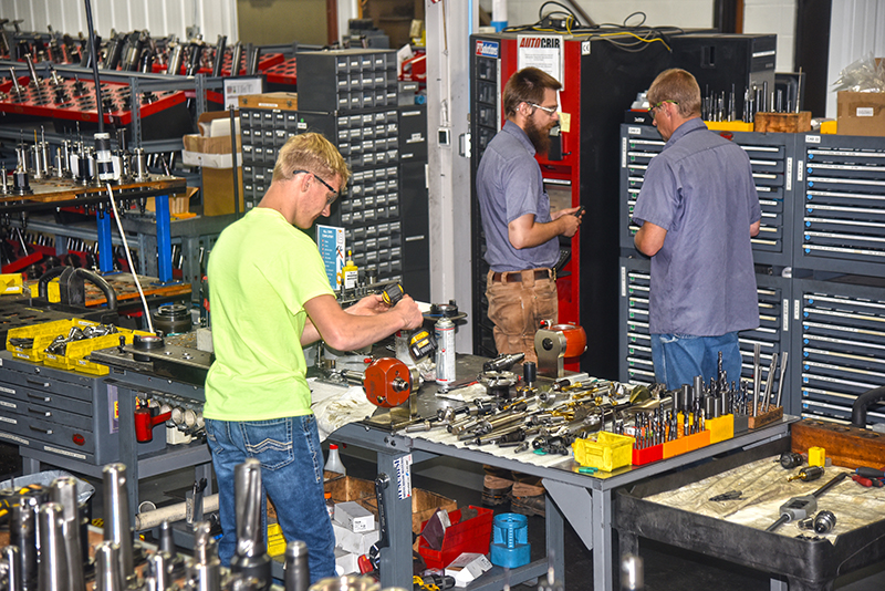 Three A to Z employees working around work bench