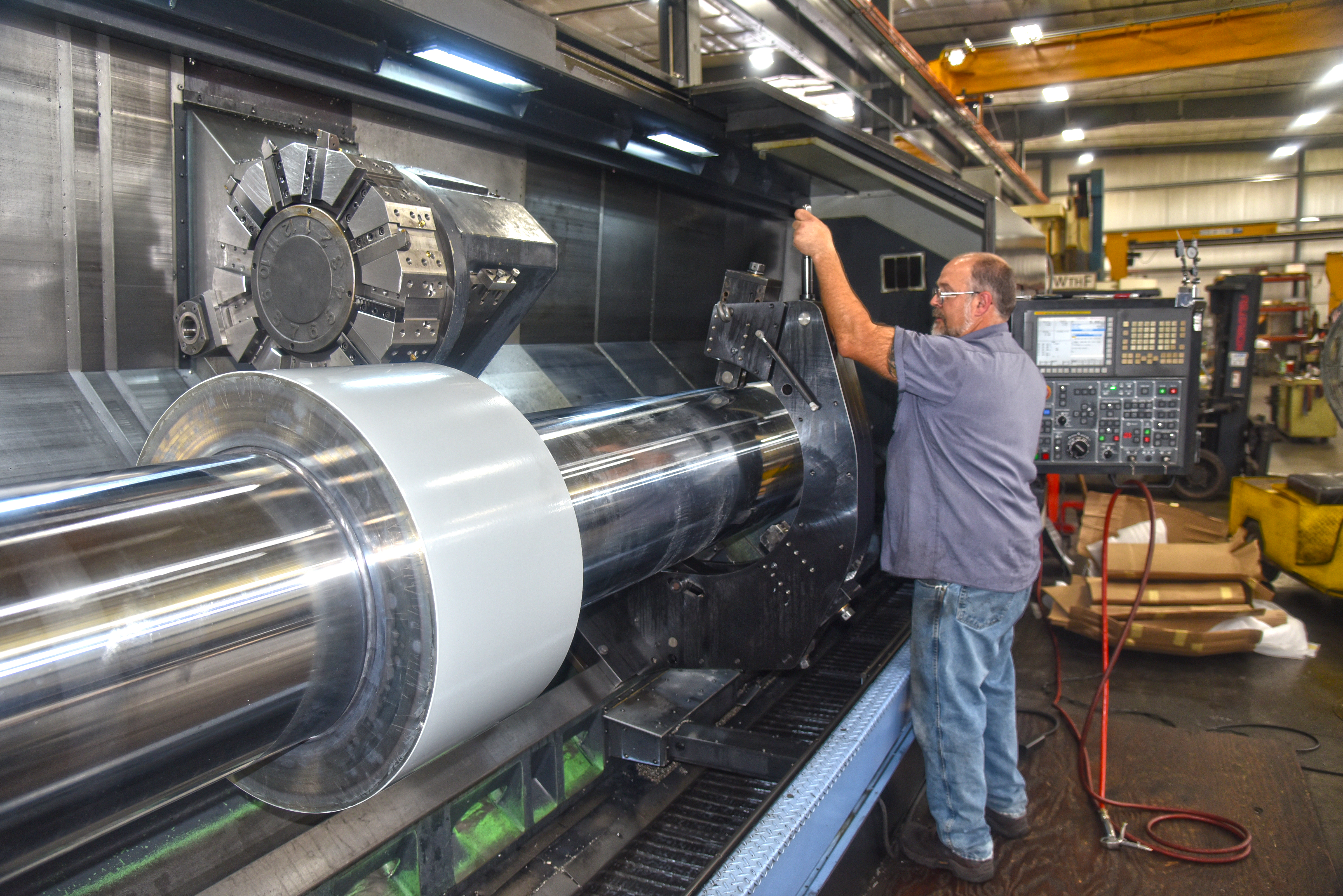 An A to Z machinist working on large metal component