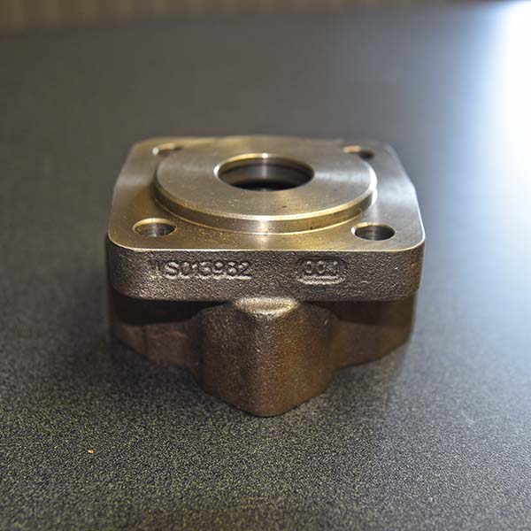 a custom machined coupler laying on a table