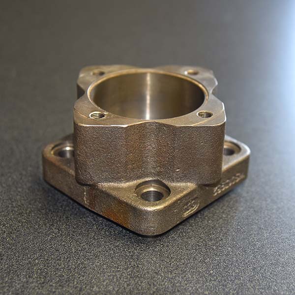 a custom machined coupler laying on a table