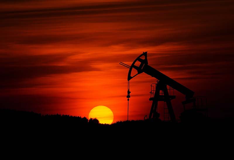 an oil pump at sunset